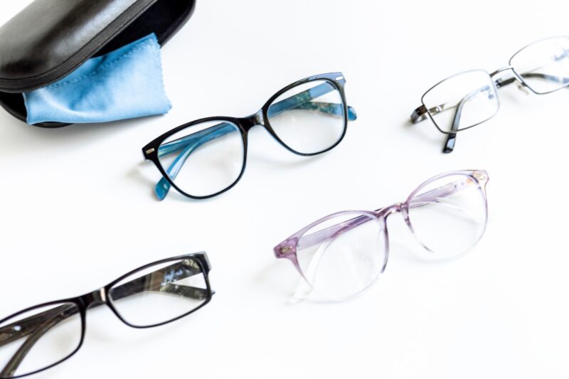 Eyeglass frames representing lens material options including high index and Trivex lenses for complex prescriptions