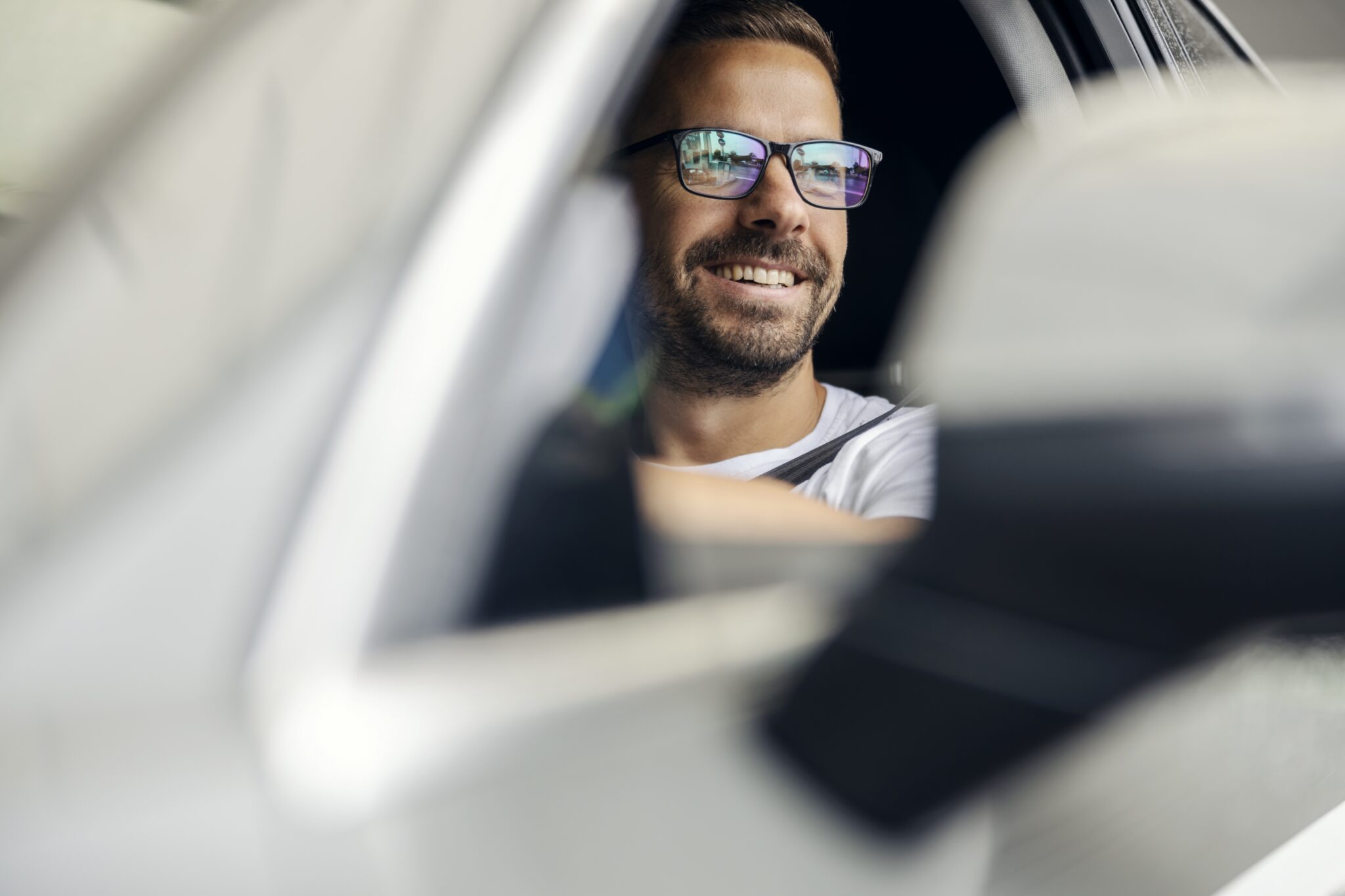 Photochromic lenses in the car staying clear behind a windshield that blocks the UV needed to activate them