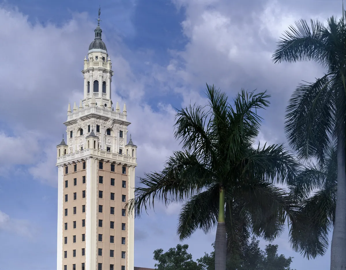 Freedom Tower, a Mediterranean Revival tower with a tall cupola, framed by palm trees in downtown Miami