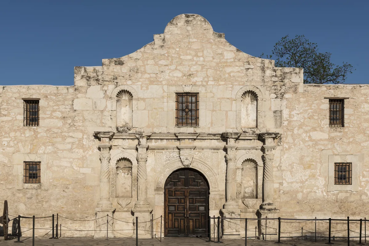 Stone facade of the Alamo mission church in San Antonio, Texas, on a sunny day